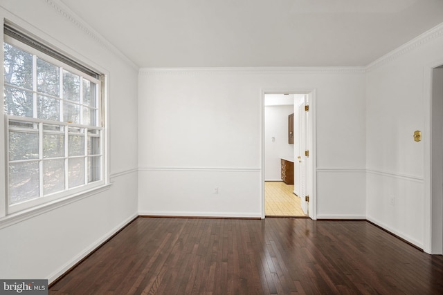 spare room with dark hardwood / wood-style floors and ornamental molding