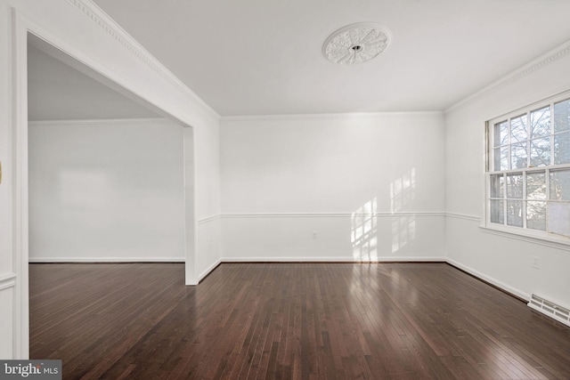 spare room featuring crown molding and dark hardwood / wood-style flooring