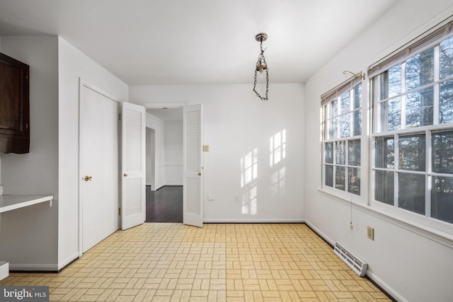 unfurnished dining area featuring a baseboard radiator