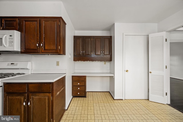 kitchen with white appliances and dark brown cabinetry