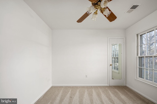 unfurnished room with ceiling fan and carpet floors