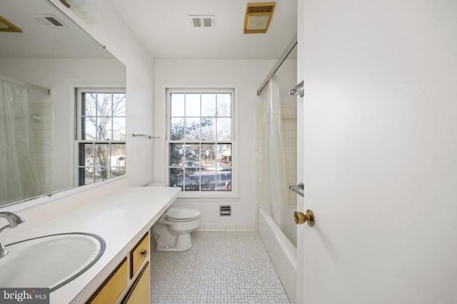 full bathroom featuring tile patterned flooring, shower / bath combination with curtain, vanity, and toilet