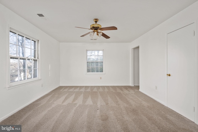 empty room featuring light carpet and ceiling fan