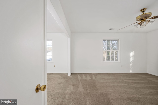 spare room featuring light colored carpet and ceiling fan