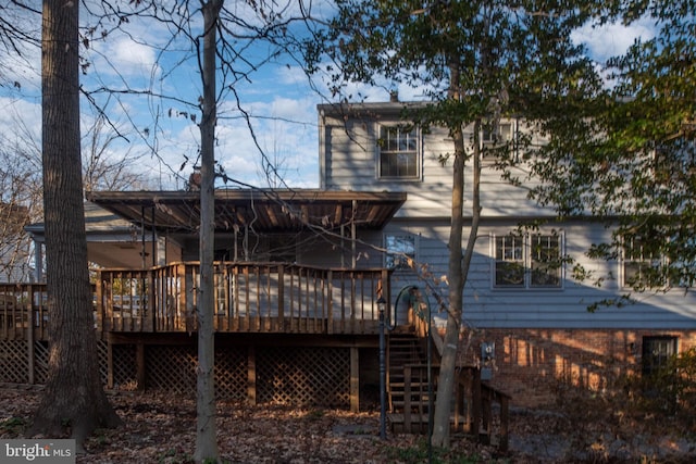 rear view of house featuring a deck