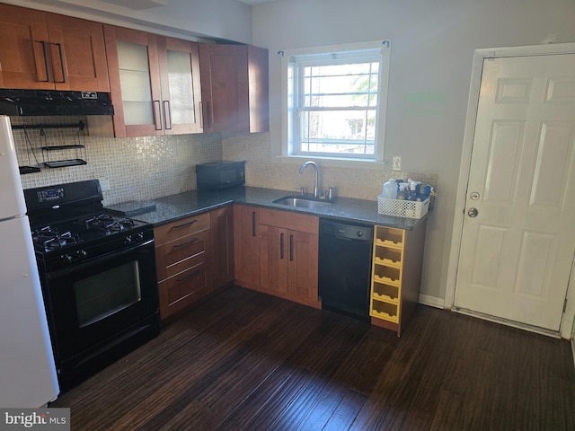 123 N Belnord Ave, Baltimore, MD 21224 - kitchen featuring black appliances, a sink, under cabinet range hood, dark wood finished floors, and tasteful backsplash
