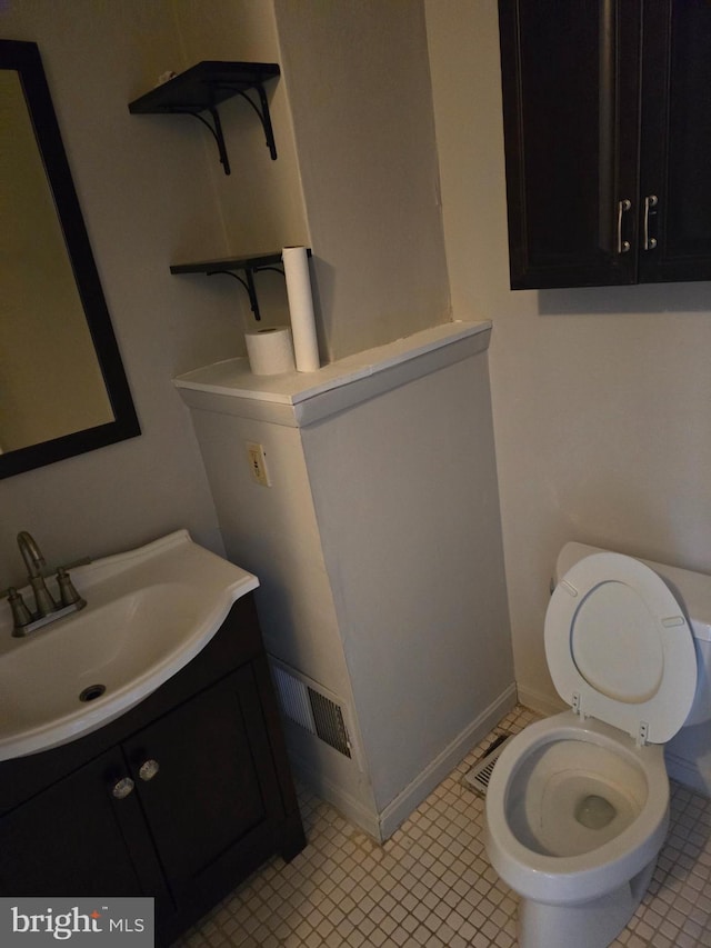 123 N Belnord Ave, Baltimore, MD 21224 - half bathroom featuring vanity, toilet, and baseboards