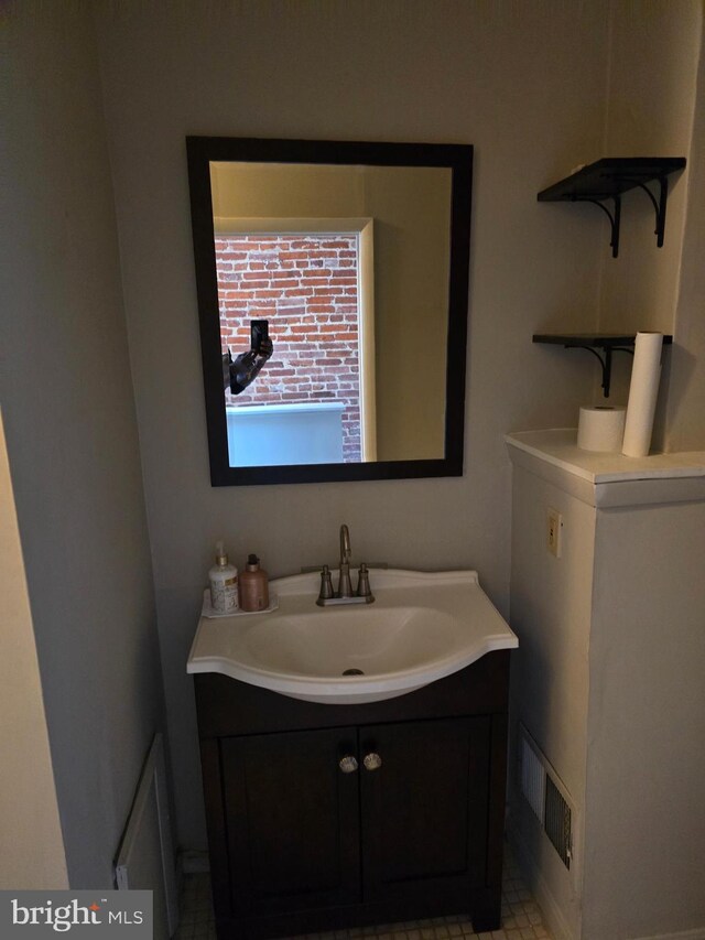 bathroom with tile patterned flooring and vanity