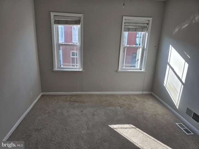 123 N Belnord Ave, Baltimore, MD 21224 - carpeted empty room with plenty of natural light and baseboards