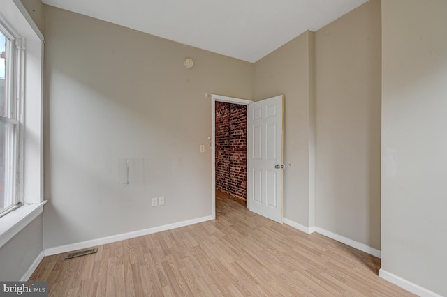 spare room featuring light wood-type flooring