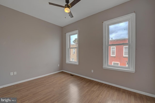 empty room featuring light hardwood / wood-style flooring and ceiling fan