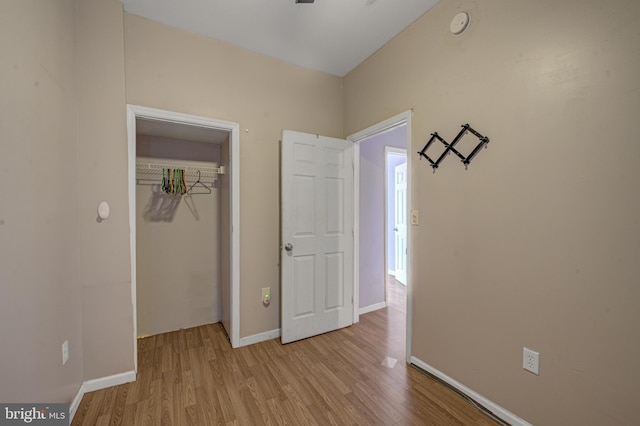 unfurnished bedroom featuring light hardwood / wood-style flooring and a closet