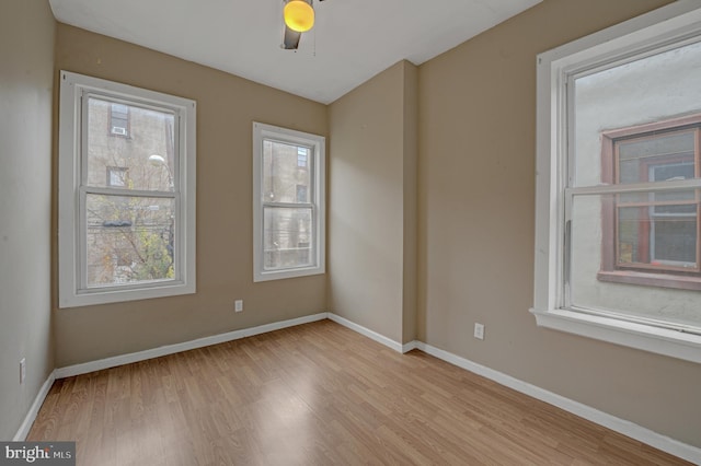 unfurnished room featuring light hardwood / wood-style flooring and ceiling fan