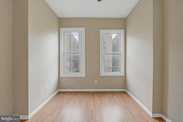 empty room with light hardwood / wood-style flooring