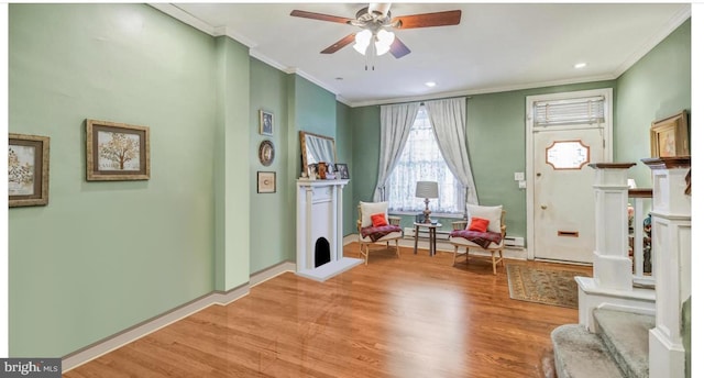 foyer with light hardwood / wood-style floors, ornamental molding, and ceiling fan