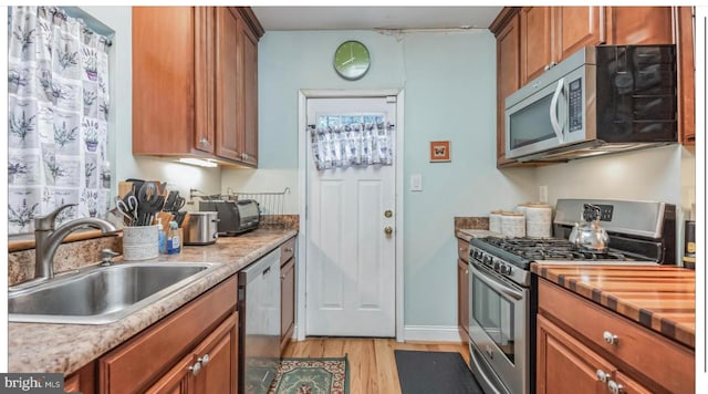 kitchen featuring sink, light hardwood / wood-style flooring, and stainless steel appliances