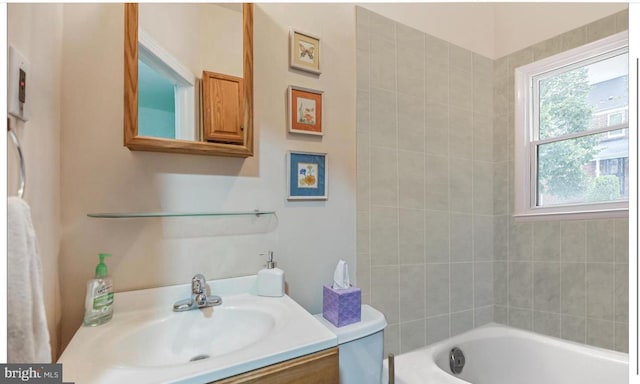 bathroom with vanity, toilet, and a bathtub