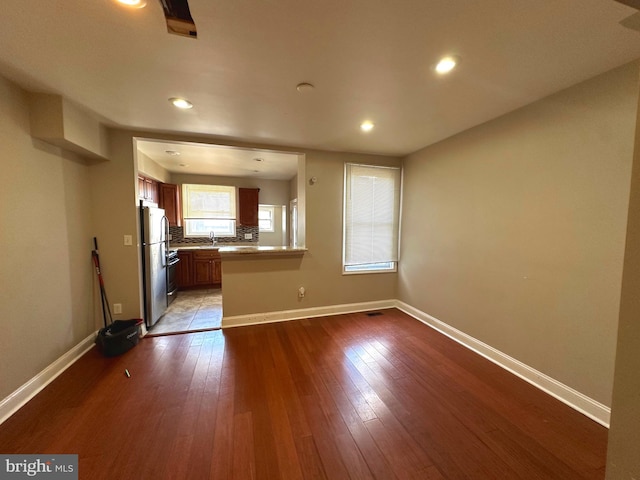 unfurnished living room with light hardwood / wood-style floors and sink