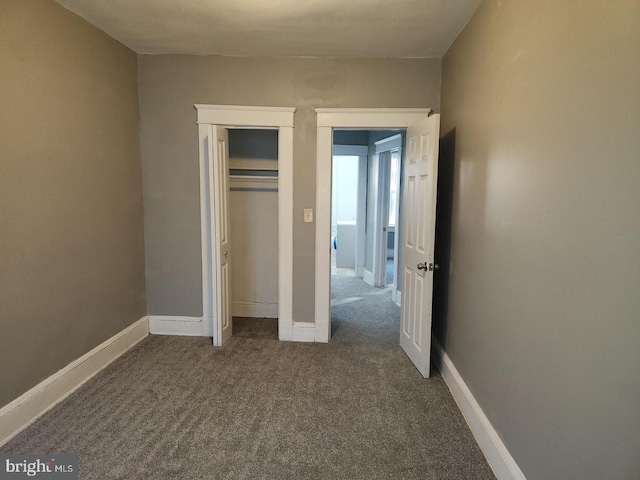 unfurnished bedroom with a closet and carpet flooring