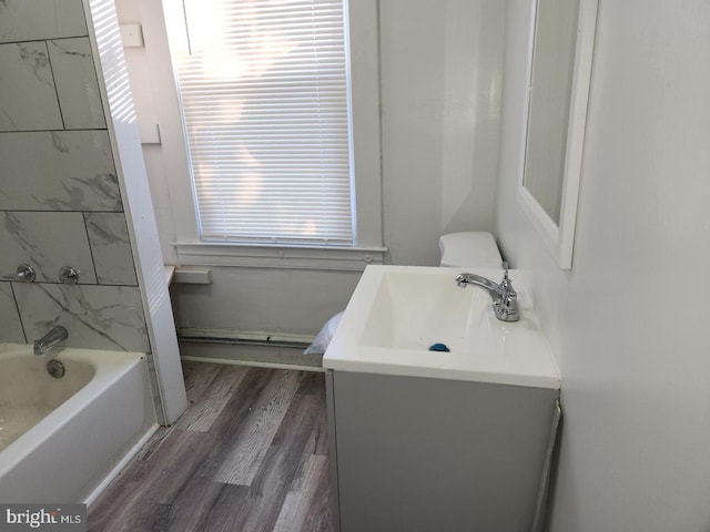 full bathroom featuring vanity, toilet, wood-type flooring, and shower / bathtub combination