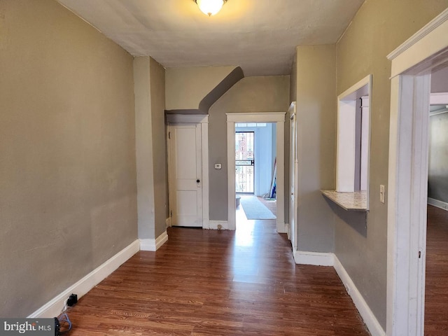 corridor with dark wood-type flooring