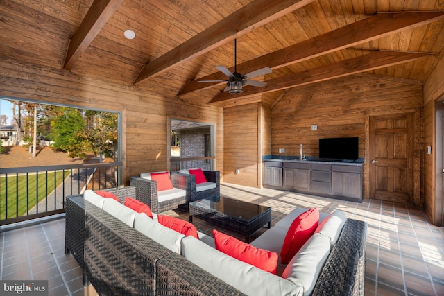 view of patio / terrace with an outdoor living space, ceiling fan, and an outdoor kitchen