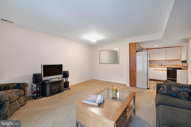 carpeted living room featuring sink