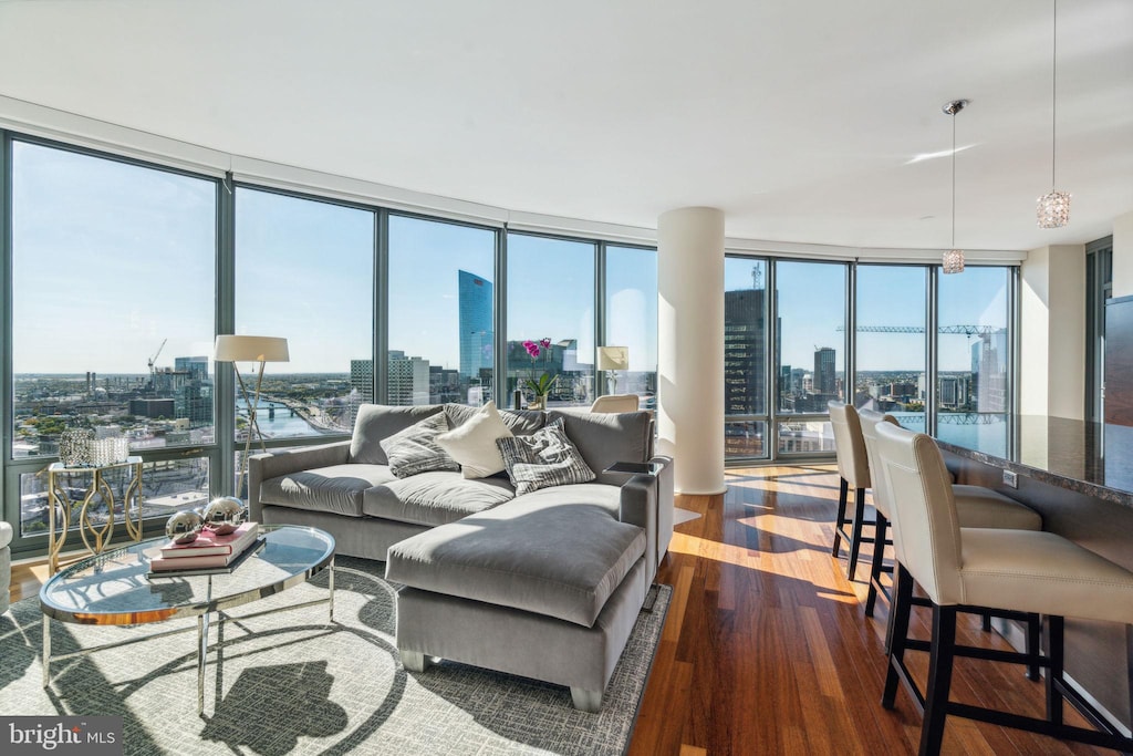 living room with wood-type flooring and floor to ceiling windows