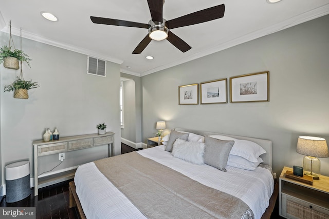 bedroom featuring ornamental molding, dark wood-type flooring, and ceiling fan