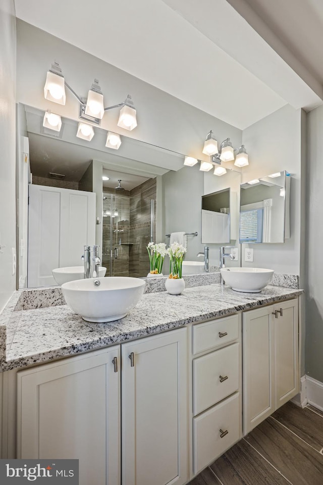 bathroom featuring vanity, hardwood / wood-style floors, and a shower with shower door