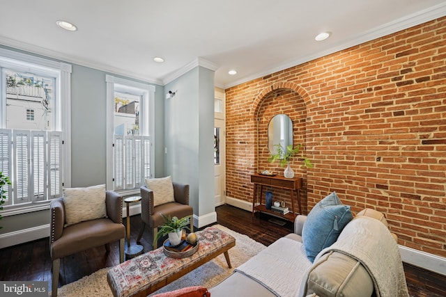 living room featuring ornamental molding, brick wall, and dark hardwood / wood-style flooring