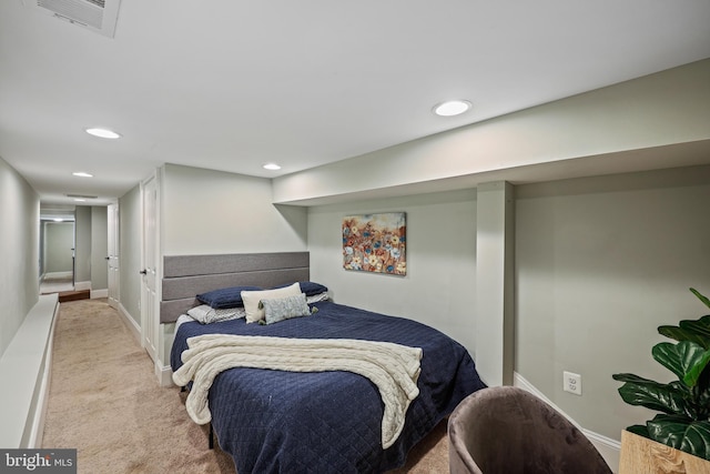 bedroom with light colored carpet