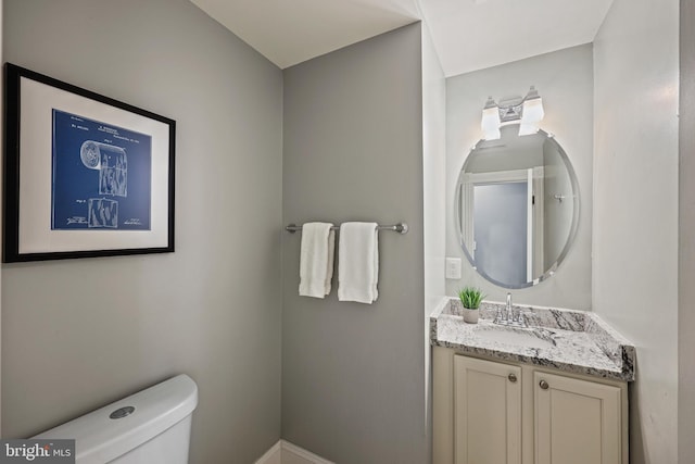 bathroom featuring toilet and vanity