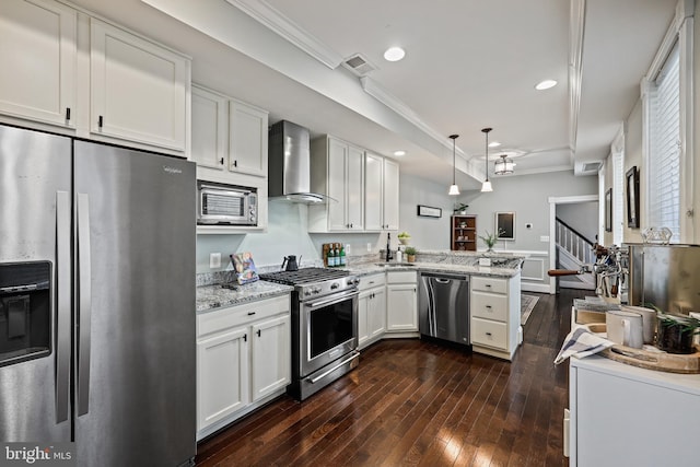 kitchen with wall chimney exhaust hood, appliances with stainless steel finishes, kitchen peninsula, and white cabinetry