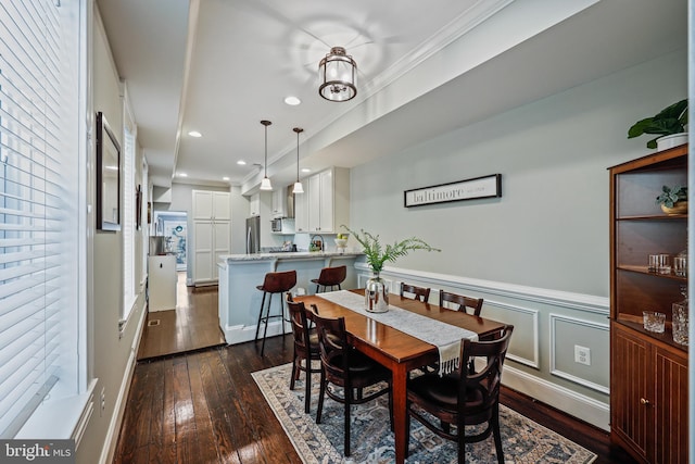 dining space featuring crown molding and dark hardwood / wood-style floors