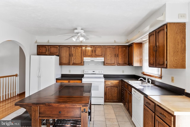 kitchen with white appliances, ceiling fan, light tile patterned flooring, and sink