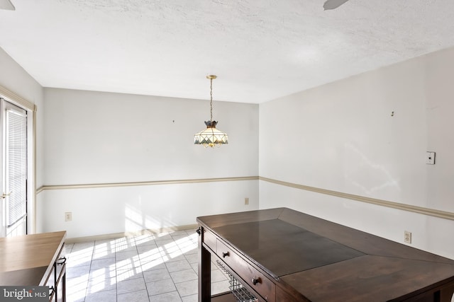 unfurnished dining area featuring a textured ceiling