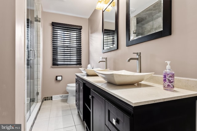 bathroom featuring vanity, toilet, walk in shower, and tile patterned flooring