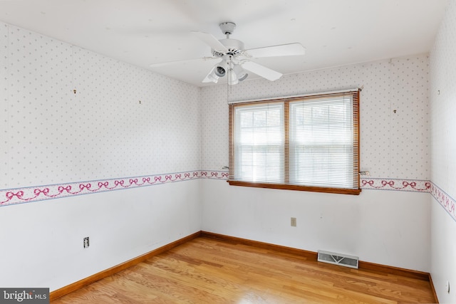 empty room featuring light hardwood / wood-style flooring and ceiling fan