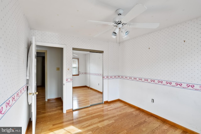 unfurnished room with hardwood / wood-style floors and ceiling fan