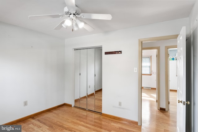 unfurnished bedroom with a closet, ceiling fan, and light wood-type flooring