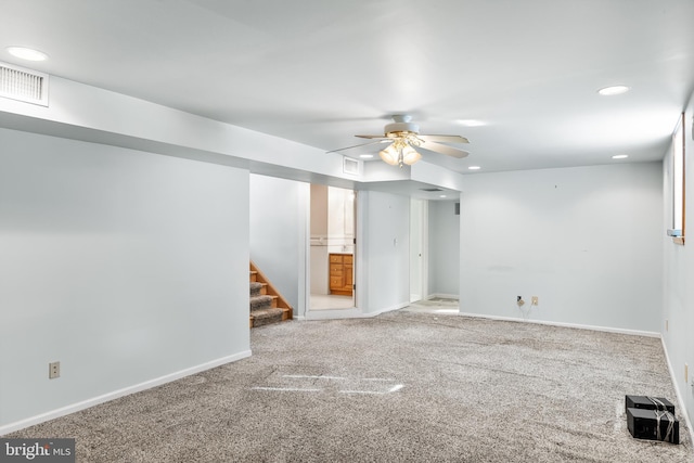 empty room featuring ceiling fan and carpet