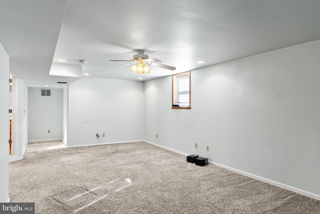 carpeted spare room featuring ceiling fan