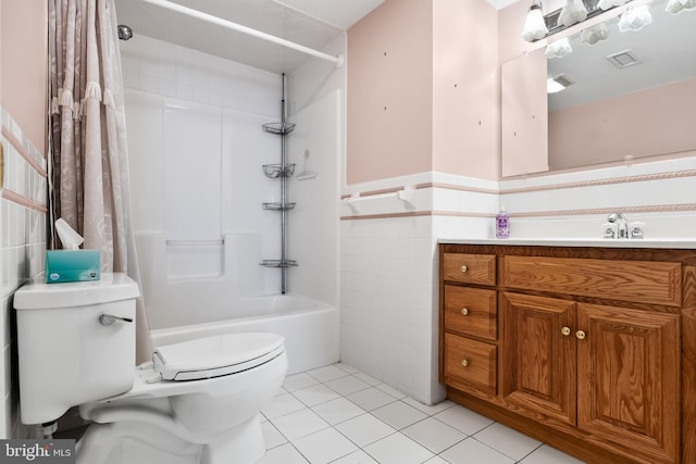 full bathroom featuring shower / bath combination with curtain, tile walls, toilet, vanity, and tile patterned flooring