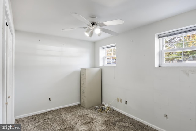 carpeted spare room with ceiling fan