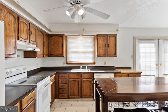 kitchen featuring black dishwasher, electric range, ceiling fan, light tile patterned flooring, and sink