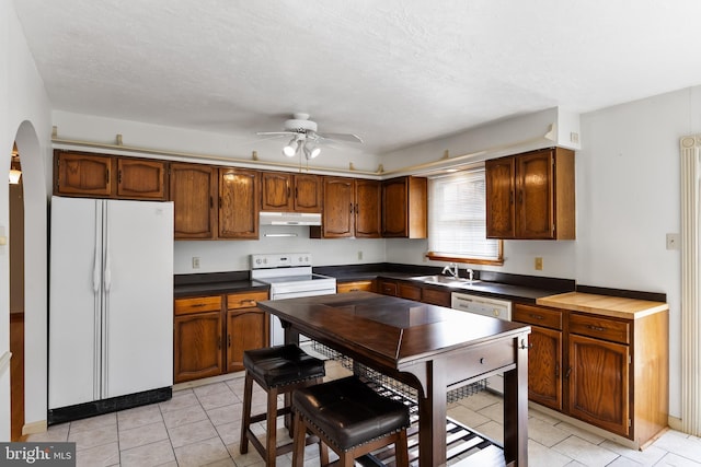 kitchen with sink, a textured ceiling, white appliances, and ceiling fan