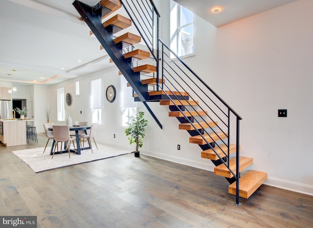 stairs featuring hardwood / wood-style flooring