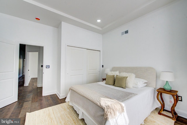 bedroom featuring a closet and dark wood-type flooring