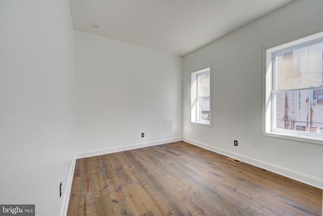 empty room with hardwood / wood-style flooring